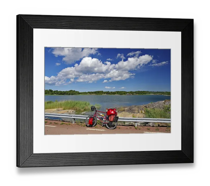 Framed Print : Bicycle with luggage leaning against a guard rail