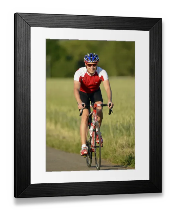 Framed Print : Racing cyclist riding a bicycle