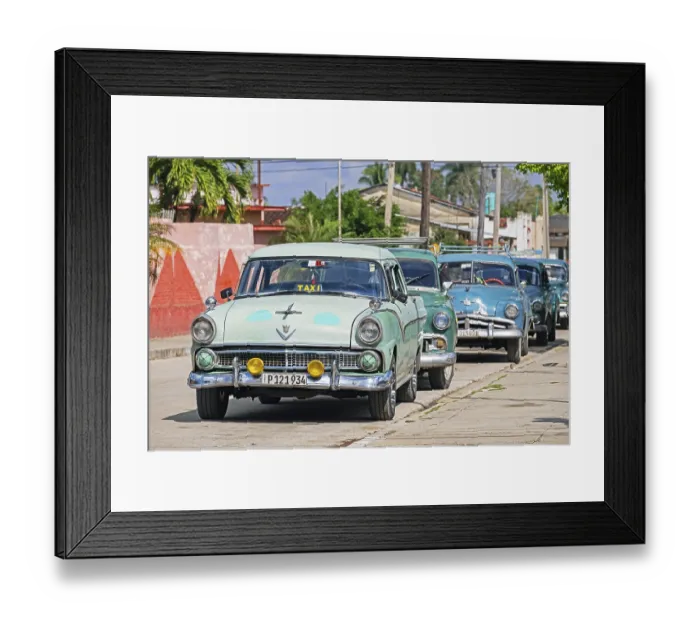 Framed Print : Parked American classic cars used as Cuban taxis in the town Jatibonico