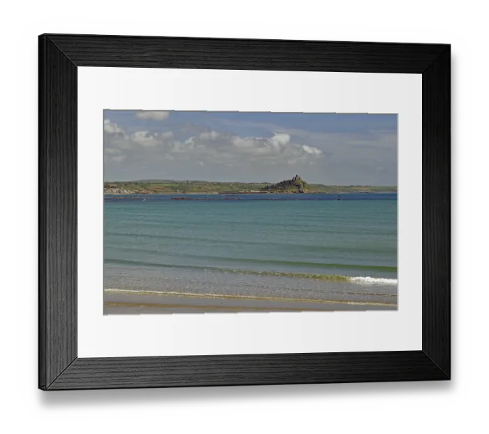 Framed Print : View of a calm coastline with island and blue sea under a slightly cloudy sky