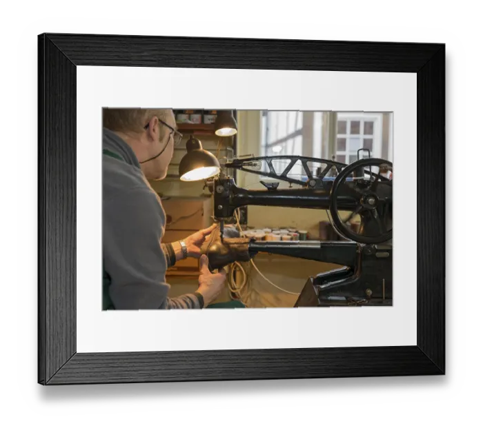 Framed Print : Shoemaker, shoemaker sews shoe to machine