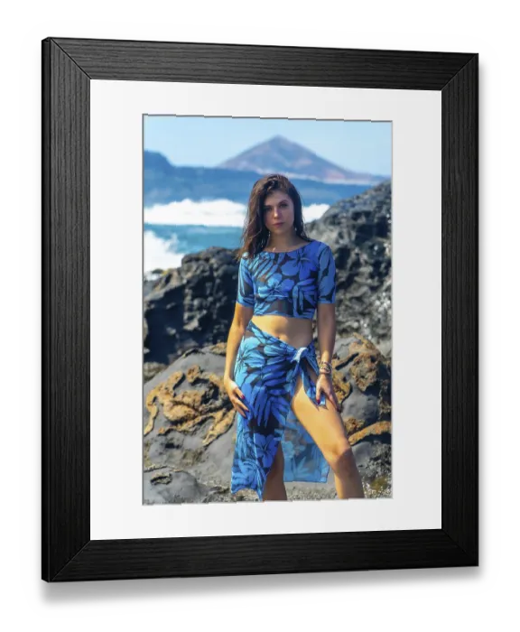 Framed Print : Fashion model posing on volcanic rocks with ocean waves and teide volcano in the background in arucas