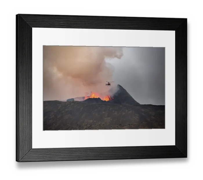 Framed Print : Helicopter flying over smoking active volcanic crater