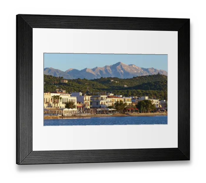 Framed Print : Coastal town at sunrise with a view of the sea and mountains in the background Framed Print : Coastal town at sunrise with a view of the sea and mountains in the background