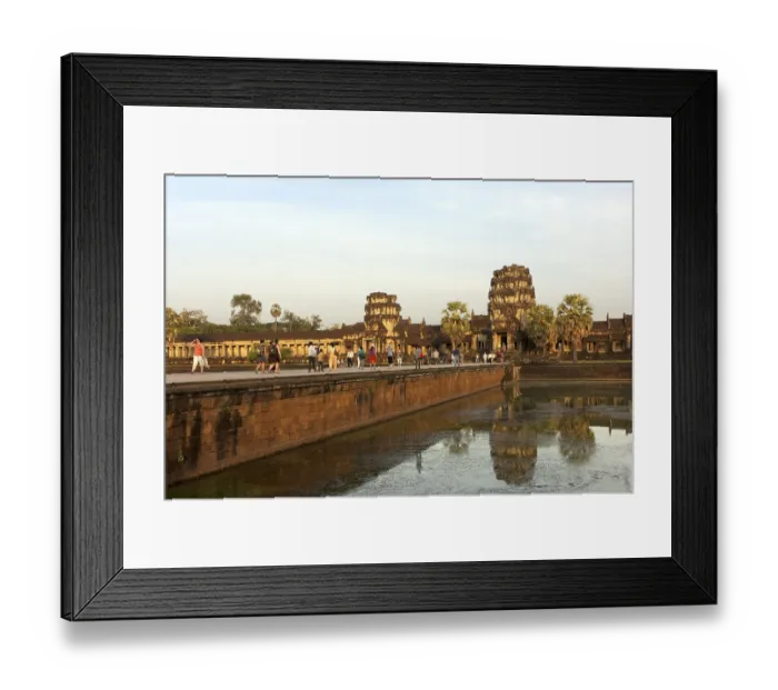 Framed Print : View across the castle bridge on the west wing of the Angkor Wat temple complex in the evening light Framed Print : View across the castle bridge on the west wing of the Angkor Wat temple complex in the evening light