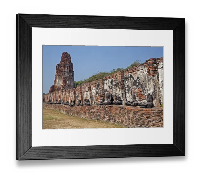 Framed Print : Ruin of a Buddhist stupa with a row of broken Buddha statues at Wat Mahathat in Ayutthaya Historical Park