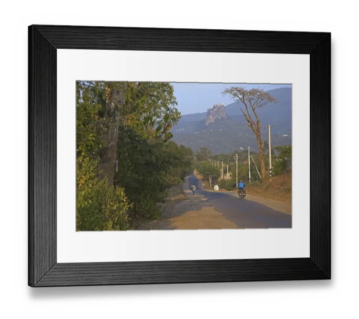 Framed Print : Tourist cycling towards Buddhist monastery on the summit of Taung Kalat near the volcano Mount Popa Framed Print : Tourist cycling towards Buddhist monastery on the summit of Taung Kalat near the volcano Mount Popa