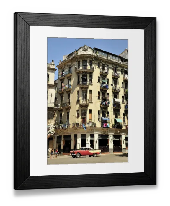 Framed Print : Vintage car in front of buildings with colourful facades