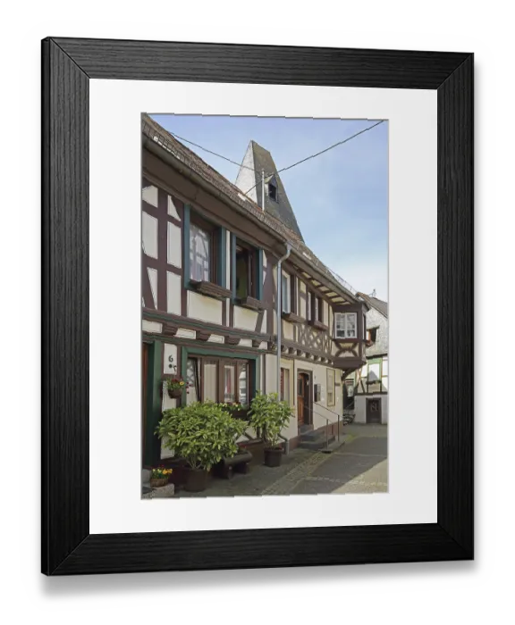 Framed Print : Half-timbered house and spire of the clock tower