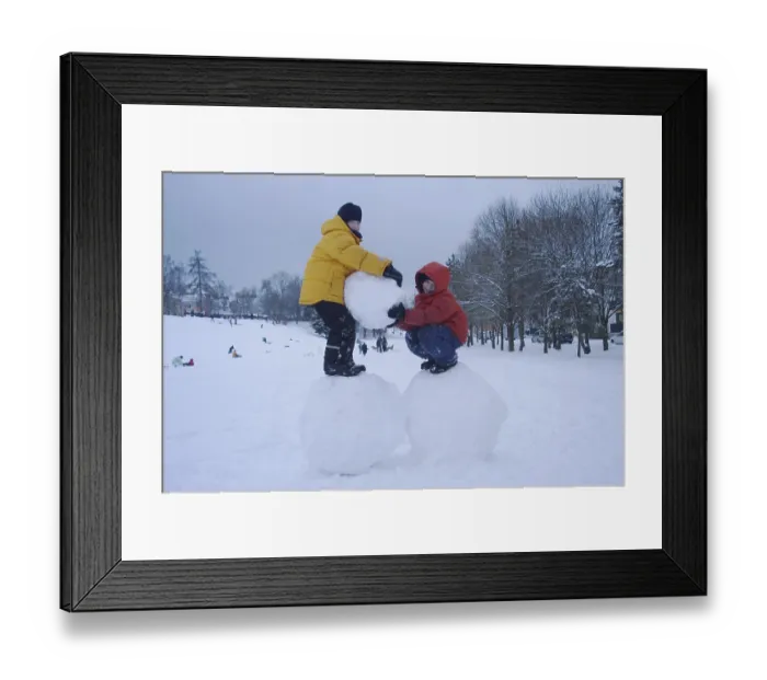 Framed Print : Two boys standing on big snoww balls Framed Print : Two boys standing on big snoww balls