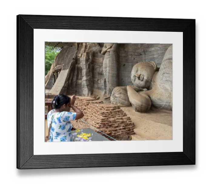 Framed Print : Praying woman in front of a reclining Buddha statue