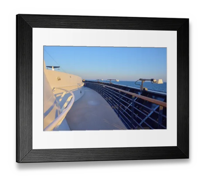 Framed Print : Deck of a cruise ship with clear blue sky and blue railing