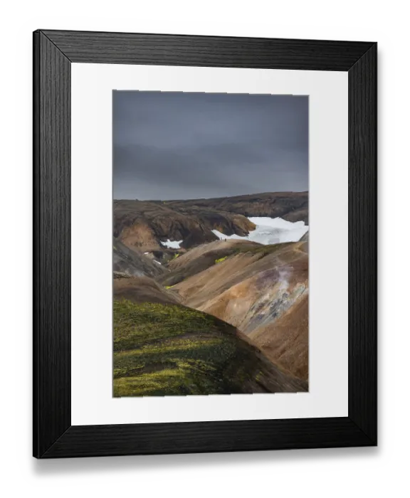 Framed Print : Hikers on colourful rhyolite mountains with remnants of snow