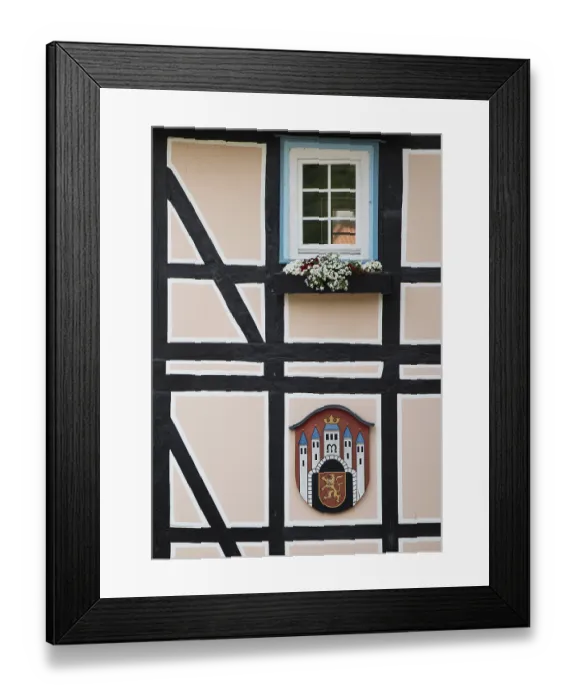 Framed Print : Half-timbered houses with town coat of arms