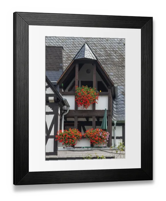 Framed Print : Balconies with lots of flowers in a typical half-timbered house with slate roof in Ernst Framed Print : Balconies with lots of flowers in a typical half-timbered house with slate roof in Ernst
