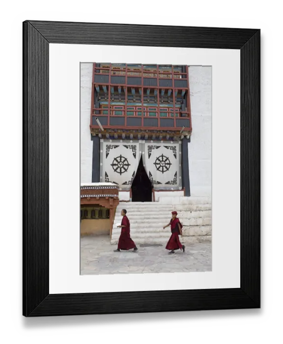 Framed Print : Two novices walk across the monastery courtyard