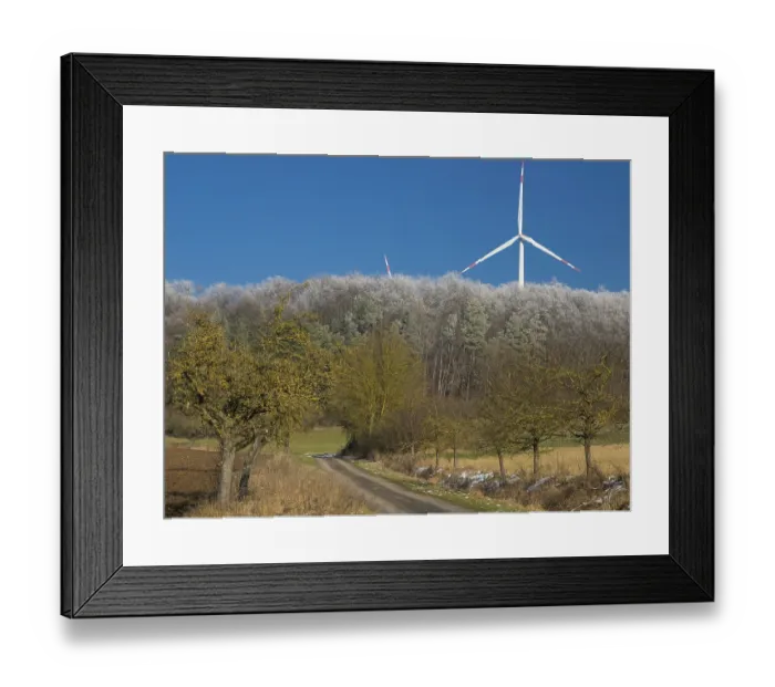 Framed Print : Wind turbines, in the middle of a hoarfrost covered forest