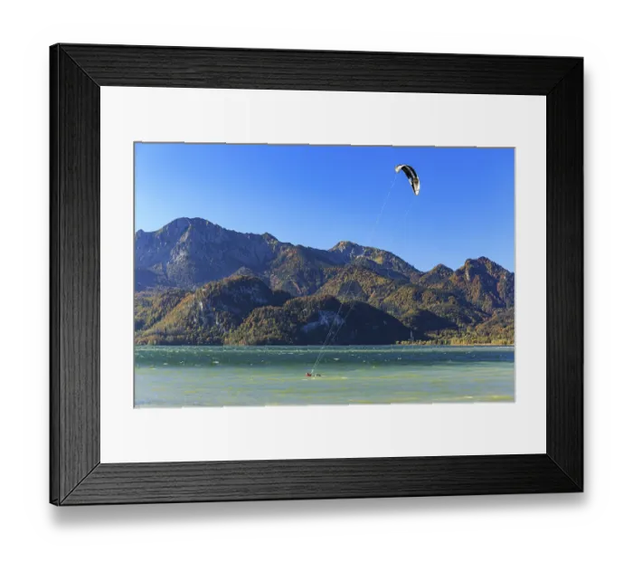 Framed Print : Kite surfer on a lake in front of mountains