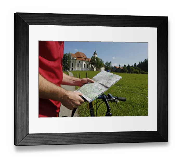 Framed Print : Cyclist holding a map, in the back Wies