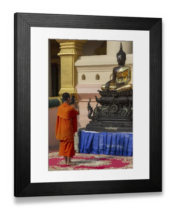 Framed Print : Monk in front of a Buddha statue