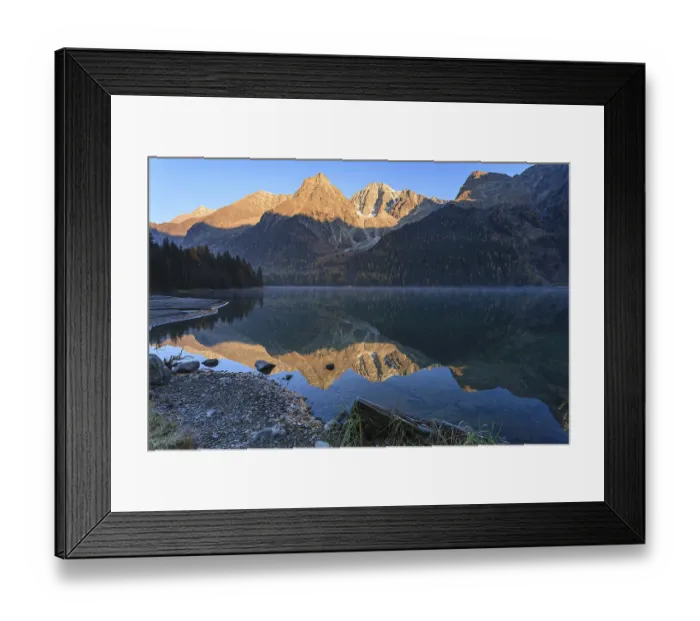 Framed Print : Mountains reflected in lake at sunrise