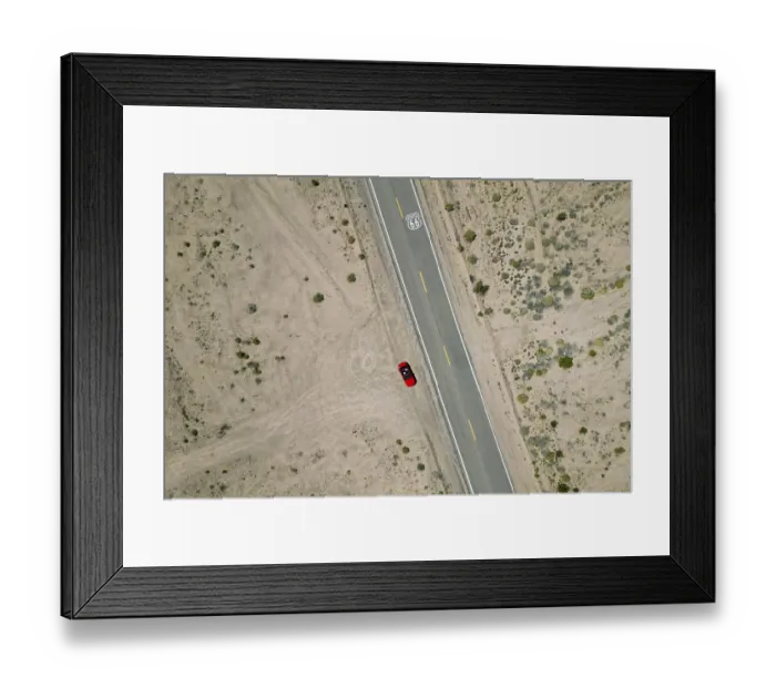 Framed Print : Drone shot of Route 66 with Route 66 sign on the road and red Ford Mustang convertible Framed Print : Drone shot of Route 66 with Route 66 sign on the road and red Ford Mustang convertible