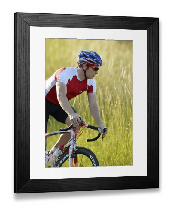Framed Print : Racing cyclist riding a bicycle