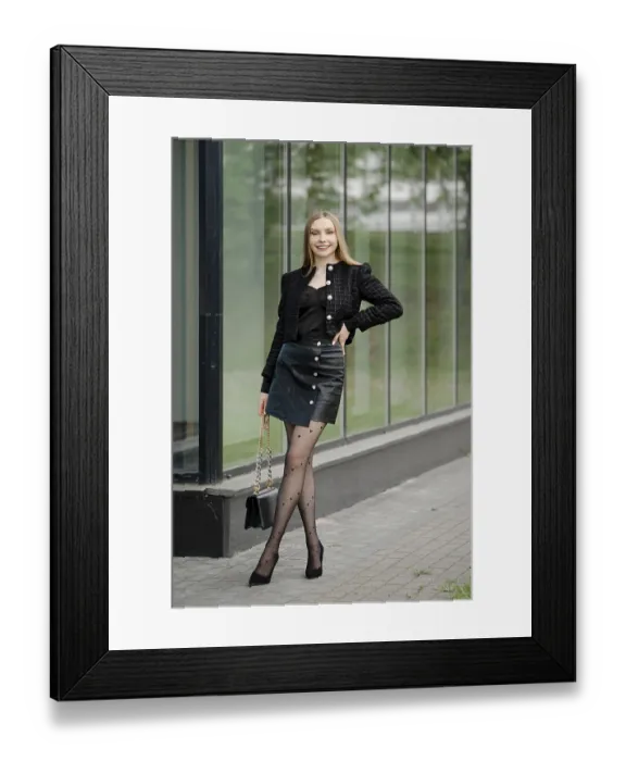 Framed Print : Cheerful young woman stopped near an office building with large glass walls