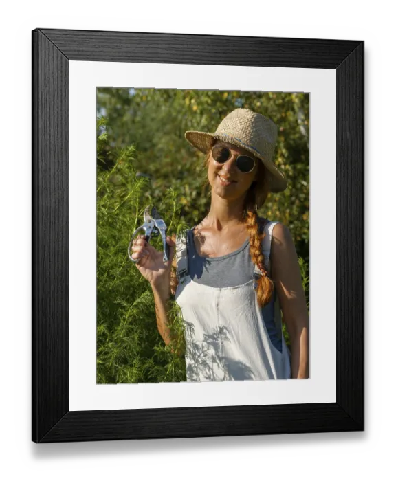 Framed Print : Woman in herb bed, medicinal herbs in garden