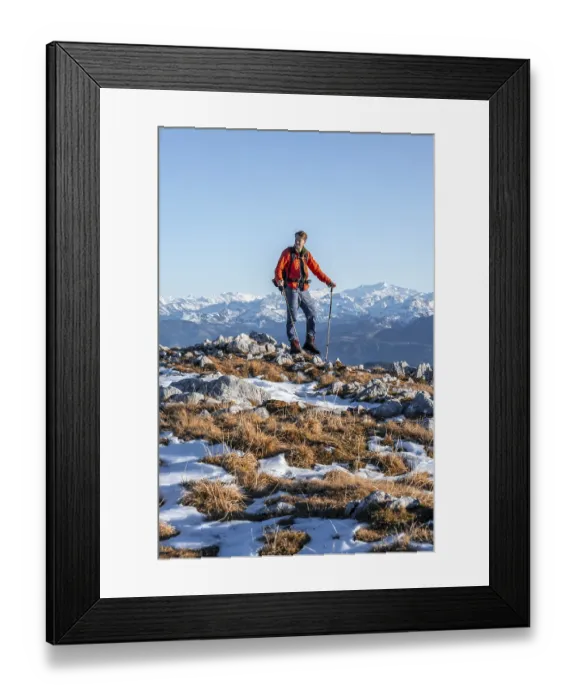 Framed Print : Mountaineer in front of mountain panorama