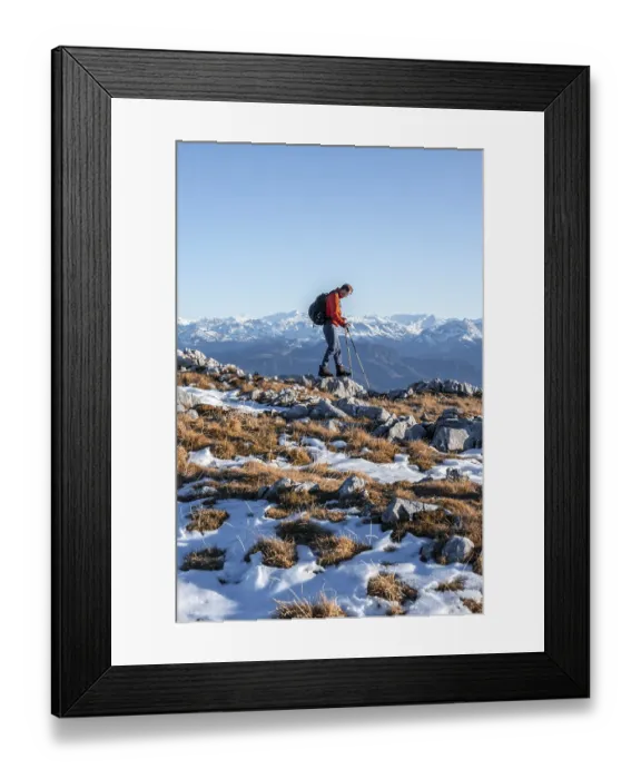 Framed Print : Mountaineer hiking in front of mountain panorama