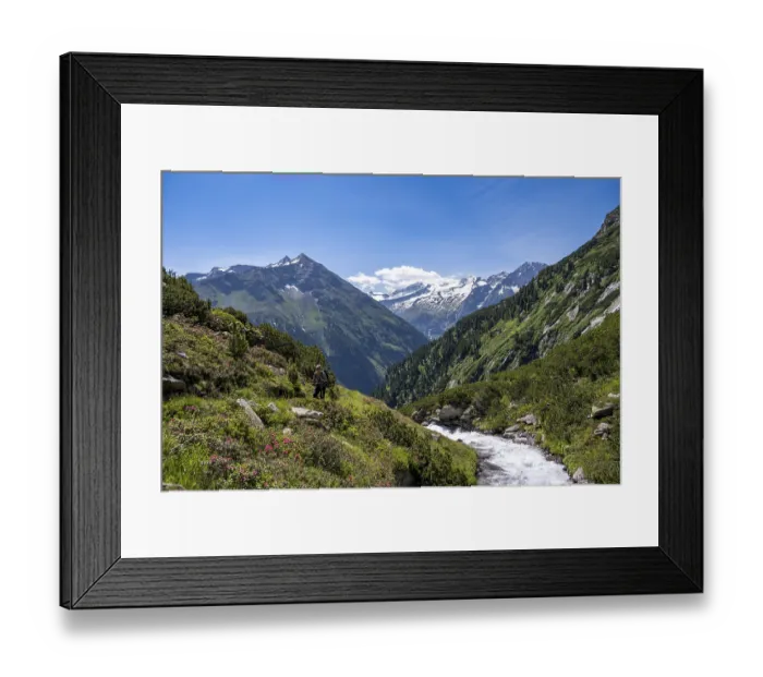 Framed Print : Mountaineer on a hiking trail by a stream