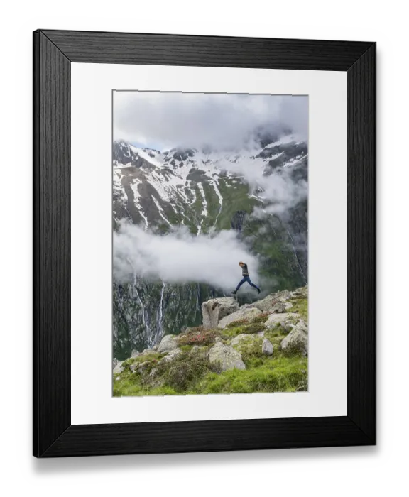 Framed Print : Mountaineer jumping from one rock to the next