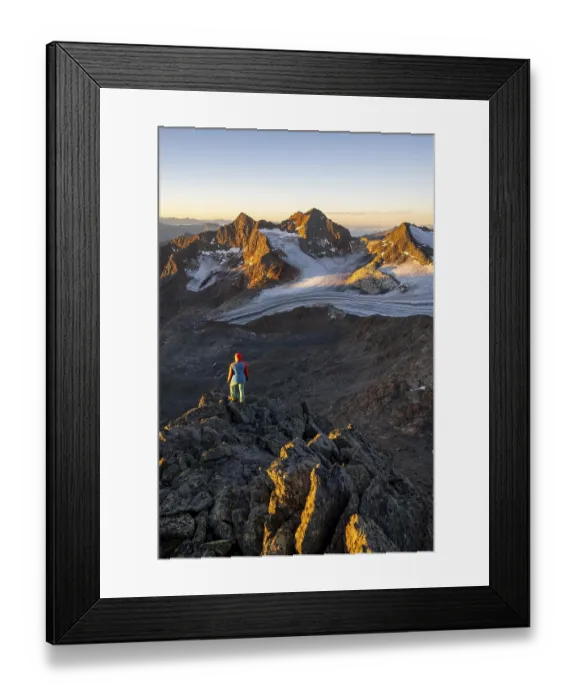 Framed Print : Mountaineer in front of picturesque high mountain landscape at sunrise with alpenglow Framed Print : Mountaineer in front of picturesque high mountain landscape at sunrise with alpenglow