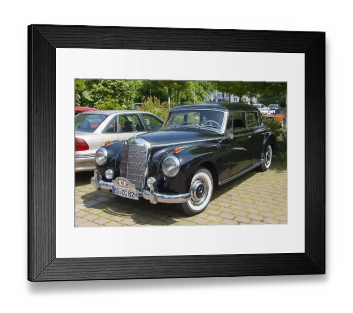 Framed Print : Elegant black Mercedes vintage car parked on a cobblestone car park surrounded by trees