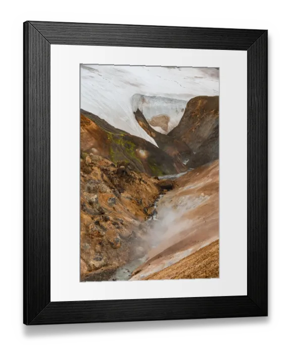 Framed Print : Steaming stream between colourful rhyolite mountains and snowfields
