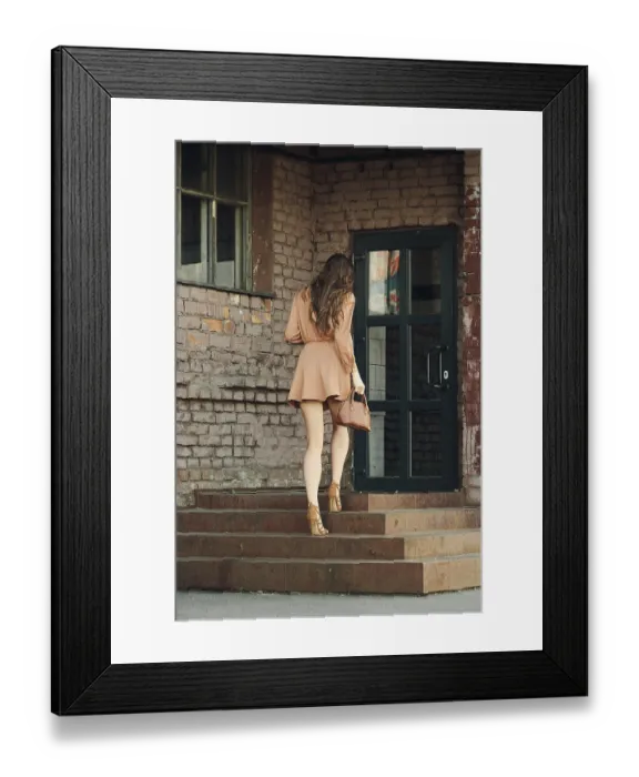 Framed Print : Back view of pretty young woman climbing the stairs of old building