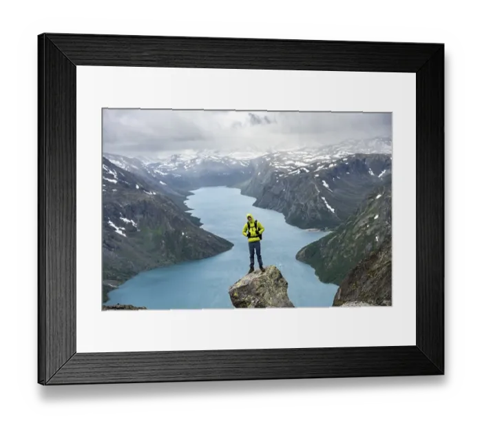 Framed Print : Climber standing on rocks, Besseggen hike