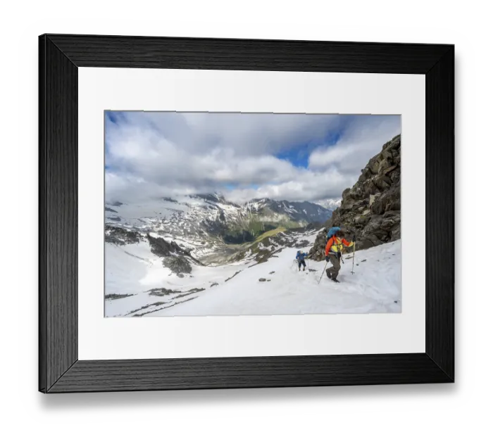 Framed Print : Two mountaineers on a hiking trail in the snow