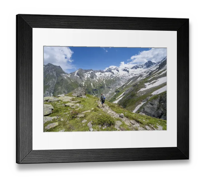 Framed Print : Mountaineer on hiking trail in picturesque mountain landscape
