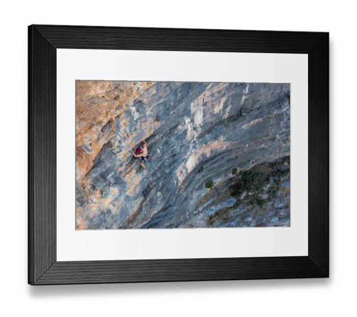 Framed Print : Climber climbing on a rock face