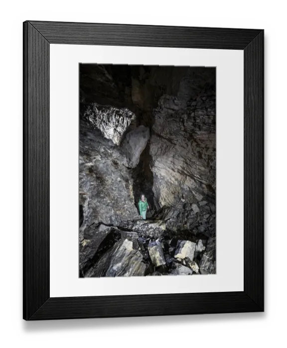 Framed Print : Hiker explores Obstans ice cave in Alta Pusteria
