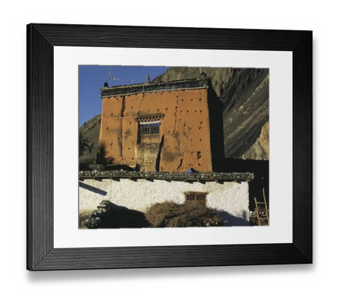 Framed Print : The village shrine or gompa with cliffs behind in the village of Kagbeni in southern Mustang in west Nepal