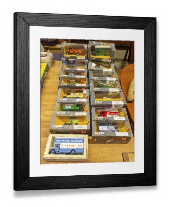 Framed Print : Boxes of Corgi model trucks, vans and other vehicles on display at auction