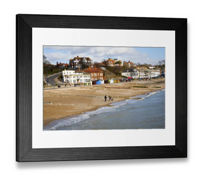 Framed Print : Sandy beach and historic buildings on the seafront on a sunny day in winter at Felixstowe
