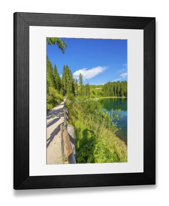 Framed Print : Tourists walking on gravel path along shore of lake carezza