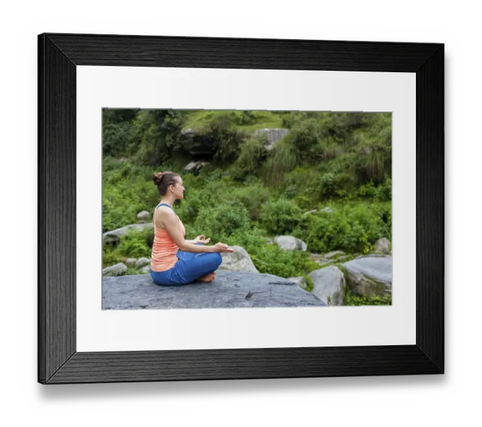 Framed Print : Woman in Hatha yoga asana Padmasana outdoors