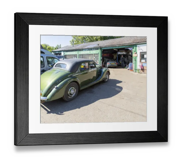 Framed Print : Classic vintage car on forecourt of village car mechanics garage