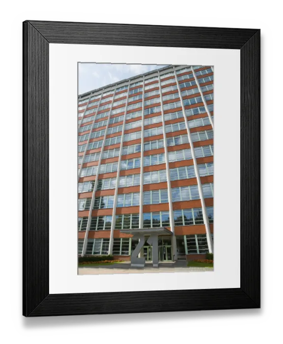 Framed Print : Tall office building with symmetrical window elements and a modern facade under a slightly cloudy sky