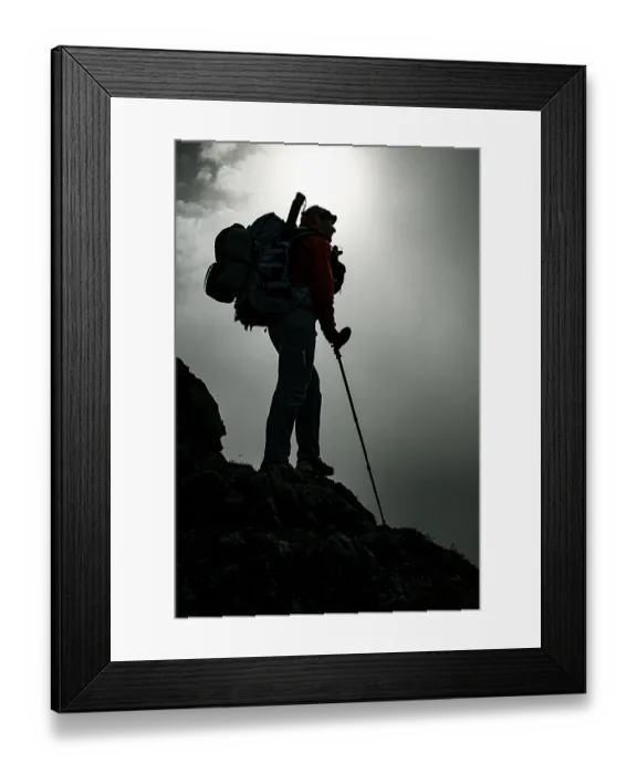 Framed Print : Mountaineer with luggage in the background Raetikon mountains with cloudy sky